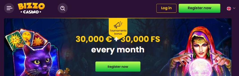 Top of the Bizzo Casino home page with log in and register buttons and a monthly tournaments banner
